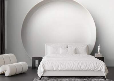 a white ceramic plate is placed on a white table, creating a simple and clean aesthetic. the plate i Wall mural