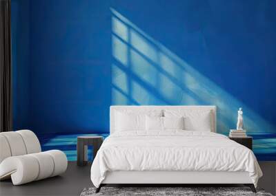 Electric blue sunlight creates geometric shadows on floor from window Wall mural