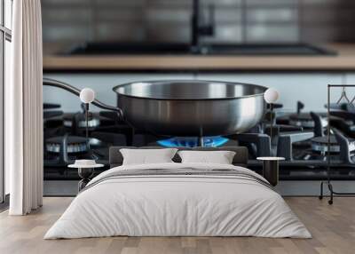 Empty pan on a gas stove with a blue frame in a contemporary kitchen, prepared for high-temperature cooking. Wall mural