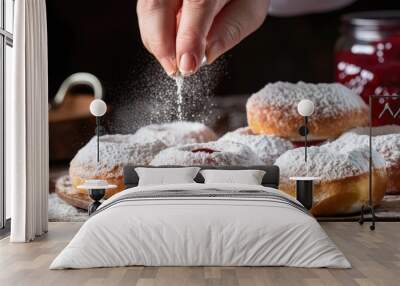 Female makes homemade jam filled donuts cooking Jewish Hanukkah treats sprinkling powdered sugar on Berliners With copyspace for text Wall mural