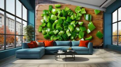 Green bell peppers diced on wooden cutting board view from above Wall mural