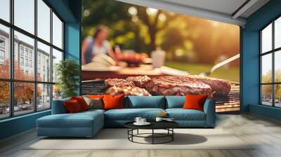 man grills steak on outdoor barbeque for family picnic in backyard. Wall mural