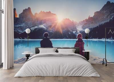 Portrait of a romantic couple of adults visiting an alpine lake at Braies Italy at winter Tourist in love drinking hot coffee at mountains Couple wanderlust and travel concept Wall mural