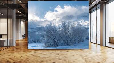 Sunlight shining on snow-covered mountains in winter Wall mural