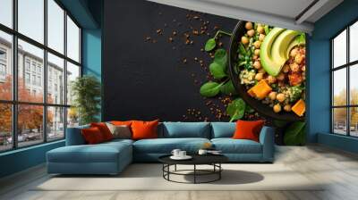 Top view of a black bowl with avocado quinoa sweet potato spinach and chickpea salad With copyspace for text Wall mural