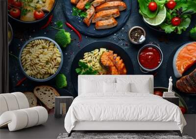 Top view of a photo collage featuring various healthy main courses, including meat and fish dishes, pasta, salads, sauces, bread, and vegetables, on a dark background. Wall mural