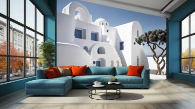 Traditional Greek architecture is in the foreground against minimalist structures. white residences at a low angle against a summer sky that is clean and blue. construction of a contemporary home esta Wall mural