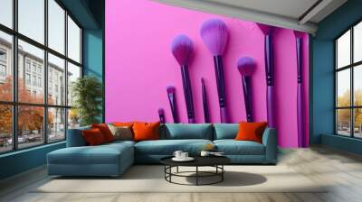 Variety of violet makeup brushes on pink backdrop for professionals Beauty tools in magazine or store Wall mural