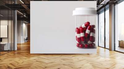 White and red pills in plastic container on white background with copy space medication idea Wall mural