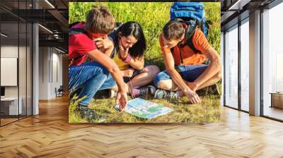 Hikers watching the map Wall mural