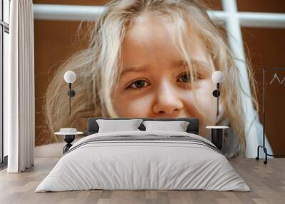 Funny sleepily cute little girl with long hair posing at home Wall mural