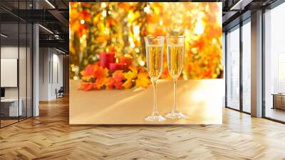 champagne glasses for reception in front of autumn background Wall mural