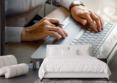 Close up shot, young businesswoman using laptop in coffee shop, crop image of manager busy working with pc, female hands typing on computer keyboard sitting at cafe wooden desk, work process concept Wall mural