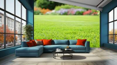 The backyard garden is full of flowers. Smooth green lawn with flowers in the background. Wall mural