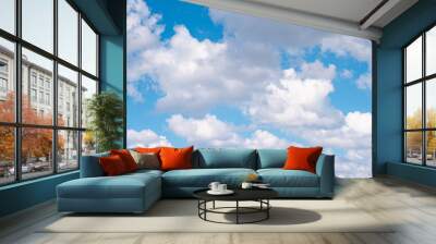 The blue sky with moving white clouds. The sky is a beautiful color shade suitable for use as a background image. Wall mural