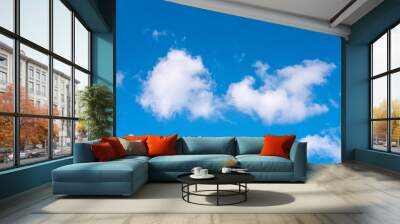 The blue sky with moving white clouds. The sky is a beautiful color shade suitable for use as a background image. Wall mural