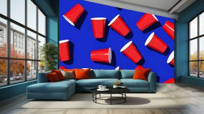 Minimal creative composition for beverage and party concept. Red plastic solo drinking cup on blue background. 3d rendering illustration. Object isolate clipping path included. Wall mural