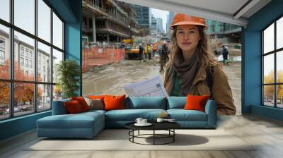 portrait of a woman with a helmet and blueprints in her hands at a construction site Wall mural