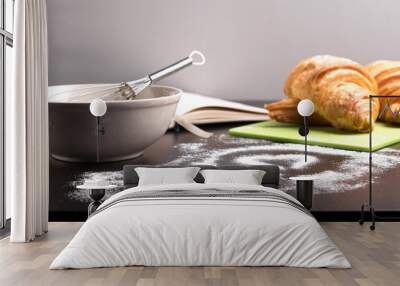 freshly baked croissants on green cutting board with flour Wall mural