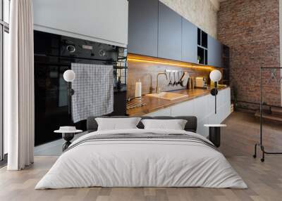 luxury studio apartment with a free layout in a loft style in dark colors. Stylish modern kitchen area with an island, cozy bedroom area with fireplace and personal gym Wall mural