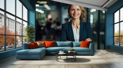 happy businesswoman at office with arms crossed Wall mural