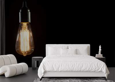 A classic Edison light bulb on black background with space for text Wall mural