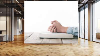 hands praying with a bible over wooden table Wall mural