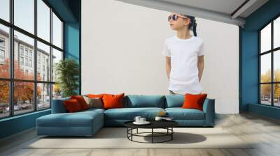 Kid girl wearing white t-shirt with space for your logo or design in casual urban style Wall mural