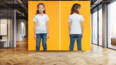 Kid girl wearing white t-shirt with space for your logo or design over yellow texture Wall mural