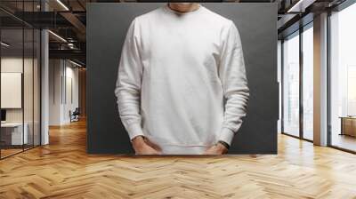 Man wearing white sweatshirt and a black hat standing over gray background. Sweatshirt or hoodie for mock up, logo designs or design prints with with free space Wall mural