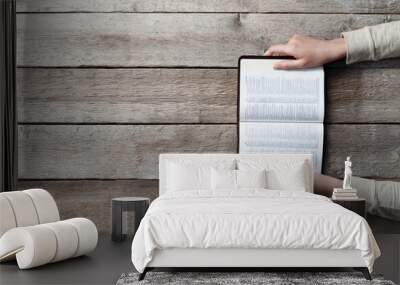 woman hands on bible. she is reading and praying over bible over wooden table Wall mural