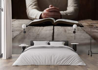 woman hands praying with a bible in a dark over wooden table Wall mural