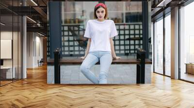 Woman or girl wearing white blank t-shirt with space for your logo, mock up or design in casual urban style Wall mural