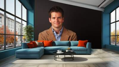 smiling man with brown jacket Wall mural