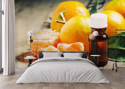 Aromatic tangerine oil, with tangerines on a wooden background, Wall mural