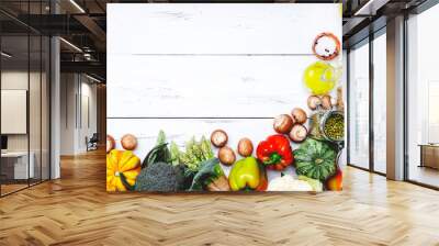 Autumn seasonal food, vegetarian cooking ingredients. Organic vegetables, pumpkin, mushrooms, asparagus, paprika, legumes, chickpeas and olive oil on rustic wooden table, copy space.  Wall mural