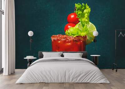 Bloody Mary classic alcoholic cocktail drink with tomato juice, vodka, lemon, celery, hot sauce and ice in glass garnished with salt and chili pepper. Green background, hard light Wall mural