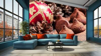 Chocolate truffles, sprinkled with cocoa powder, red Christmas b Wall mural