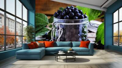 Fresh chokeberry in jar, selective focus Wall mural