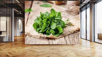 Fresh mint in a bundle, vintage wooden background, selective focus Wall mural