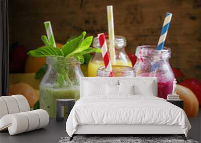 Multi-colored bottles with fresh fruit smoothies with striped st Wall mural