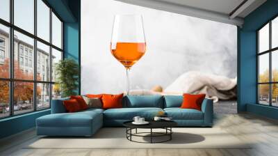 Orange wine in big wine glass, fashionable modern drink, gray counter background, copy space, selective focus Wall mural