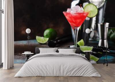 Red Watermelon alcoholic cocktail with vodka, juice, lime and crushed ice, metal bar tools, dark background Wall mural