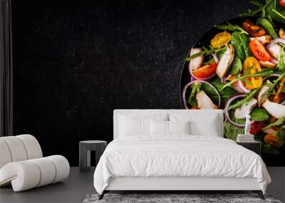 Spring salad with spinach, grilled chicken, cherry tomatoes, arugula, corn salad and red onion. Healthy food concept. Black stone table. Top view. Panoramic banner with place for text Wall mural