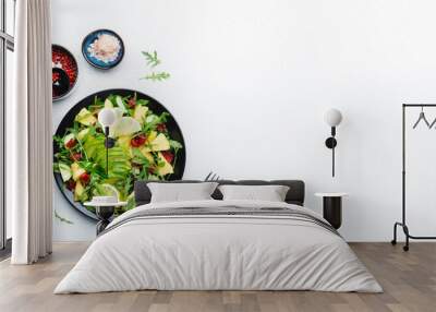 Summer vegan salad with juicy pineapple, fresh arugula, avocado and dried cranberry on white table, top view. Banner. Healthy eating, clean diet food, weight loss concept Wall mural