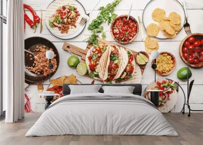 Taco party.  Served table with tortillas, nachos, sauces, appetizers and plates. Homemade mexican food cooking scene. White table background, top view Wall mural