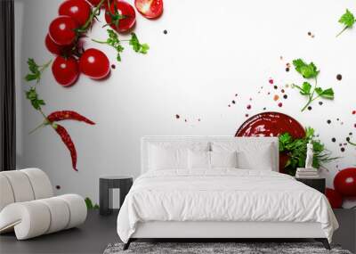 Tomato ketchup sauce with spices and herbs with cherry tomatoes in a bowl on white food background, top view Wall mural