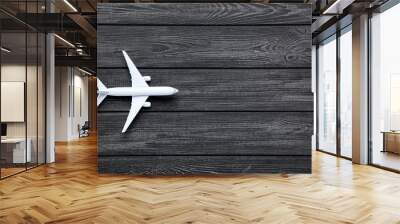 Airplane model on black wooden table Wall mural