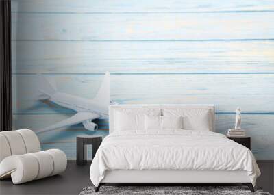 Airplane model on blue wooden table Wall mural