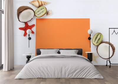 Blank sheet of paper with seashells and fruits on white wooden table Wall mural